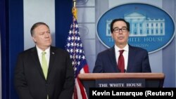 U.S. Secretary of State Mike Pompeo (left) and Treasury Secretary Steven Mnuchin announce the new sanctions at the White House.