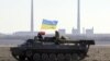 Ukraine – Ukrainian servicemen drive on an APC (Armoured Personnel Carrier) on a field close to the checkpoint near village Roty, not far from the eastern Ukrainian city of Debaltseve, Donetsk area, 22 February 2015