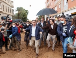 Spaniolii s-au simțit complet abandonați de autorități. Când regele Felipe (sub umbrelă) a vizitat suburbia Valenciei, Paiporta, unul dintre locurile cele mai afectate, localnicii au aruncat cu noroi în el.