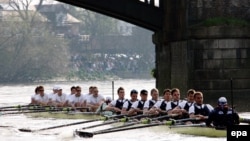 Ecipele de studenți din Cambridge (în spate) și Oxford în competiție de vâslit pe Tamisa.