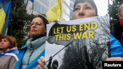 People attend a protest against the ongoing Russian full-scale invasion of Ukraine on the day of a European Union leaders summit in Brussels on October 26.