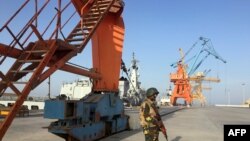 A Pakistani soldiers guarding port cranes in Gwadar, a seaport in Balochistan. 