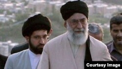 Mojtaba Khamenei (left) walks behind his father, Supreme Leader Ayatollah Ali Khamenei. (file photo)