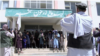 A group of Taliban fighters pose for a photo in the Zarghoo Shahr high school.