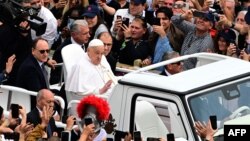 Papa Francisc salutând mulțimea în duminica Paștelui, în prima sa plimbare în aer liber cu papamobilul prin Piața Sfântului Petru de la Vatican de după cele cinci săptămâni petrecute la spital cu pneomonie bilaterală, 20 aprilie 2025. 