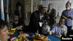 Férfiak vacsorája az egész napos böjt után ramadán idején az egyik hotani mecsetben, Kína Hszincsiang autonóm tartományában, 2021. április 29-én