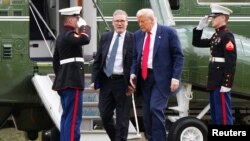 U.S. President Donald Trump and British Prime Minister Keir Starmer arrive by helicopter at Trump International Golf Links, in Aberdeen, Scotland, July 28, 2025.