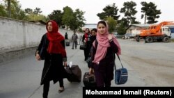 Members of the Afghan robotics girls team arrive to receive their visas from the U.S. embassy in Kabul on July 13.