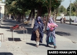 Two women walking in Kabul in 1996, when the Taliban controlled the capital.