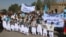 Afghans attend a rally in Herat to support the Doha peace talks between the Taliban and the Afghan government on September 21.