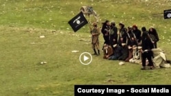 Grab from a video that shows militants loyal to the Islamic State (IS) blowing up bound and blindfolded Afghan prisoners with explosives. The victims were from Nangarhar province.