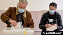 A man casts his ballot at a polling station in Sarajevo on November 15.