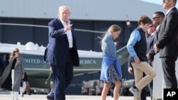 US President Donald Trump walks with his grandchildren, Chloe and Tristan, before boarding Air Force One, Tuesday, July 29, 2025, at Royal Air Force Lossiemouth en route to return to Washington. 