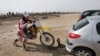 Female Iranian motorcross champion Noura Naraghi, 23, attaches her bike to her car at the conclusion of a training session in Nassim Shahr, southwest of the capital Tehran, Iran,
