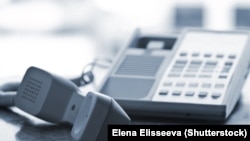 Generic - Photo ©Shutterstock. Telephone handset off the hook on desk, undated