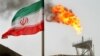 A gas flare on an oil production platform in the Soroush oil fields is seen alongside an Iranian flag in the Gulf 