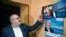 Boris Nadezhdin, the Civic Initiative Party presidential hopeful, talks to an AFP reporter by his campaign posters from past regional elections at his flat in Dolgoprudnyy on January 24, 2024.