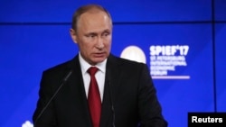 Russian President Vladimir Putin delivers a speech during the business session Russia-USA at the St. Petersburg International Economic Forum (SPIEF) on June 2. 