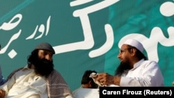 FILE: Syed Salahuddin (L), leader of the United Jihad Council, speaks with Hafiz Muhammad Saeed, chief of the banned Islamic charity Jamat-ud-Dawa, during a protest in Islamabad, Pakistan.