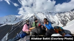 Some HikeVentures team members take a break after long hours of climbing the snow-peaked Hindu Kush Mountains in their ascent of Mount Noshaq.