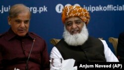 FILE: Pakistan's opposition leaders, Shehbaz Sharif (L) and Maulana Fazlur-Rehman during a meeting in Islamabad in July.