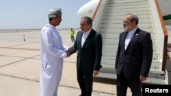 Ministri i Jashtëm iranian, Abbas Araqhchi (në mes), mirëpritet nga një zyrtar i paidentifikuar i Omanit me të mbërritur në Muscat të Omanit, për bisedime bërthamore me Shtetet e Bashkuara, më 11 maj.