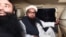 FILE: Hafiz Saeed, leader of the Jamaat-ud-Dawa (JuD) organisation Hafiz Saeed (R) leaves in a car after being detained by the police in the eastern city of Lahore in January.