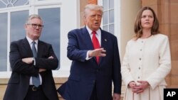 Președintele Donald Trump (în centru), vorbește cu presa, în timp ce este întâmpinat de premierul britanic, Keir Starmer (stânga), și soția acestuia, Victoria, la Turnberry, în Scoția, 28 iulie.