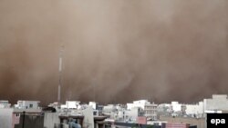 A dust storm engulfs Tehran on June 2. The storm killed five people, injured several dozen more, and knocked out power to around 50,000 homes in the Iranian capital.