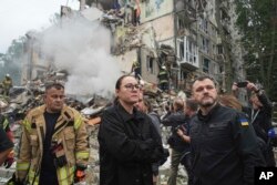 Prim-ministra Ucrainei, Iulia Sviridenko (centru) și ministrul de interne Ihor Klimenko lângă ruinele unui bloc distrus de ruși, la 31 iulie 2025.