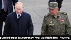 Russian President Vladimir Putin (left) and Defense Minister Sergei Shoigu (file photo)