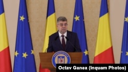 Președintele PSD, Marcel Ciolacu, la a doua nominalizare drept premier, de către președintele Iohannis. În primul mandat de premier, a aprobat cea mai mare proporție din PIB ca subvenție pentru partidele parlamentare, PSD fiind cel mai mare.