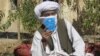Mullah Wakeel, a Taliban leader, show a copy of the Afghan Taliban's code of conduct. Scholars say the Taliban has no authority to enforce Islamic law.