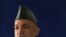 President Hamid Karzai talks to U.S. soldiers near Kabul. In Washington, he is expected to focus on winning U.S. backing for his reconciliation policies.