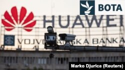 A surveillance camera is seen in front of a Huawei logo in Belgrade, Serbia. (File photo)