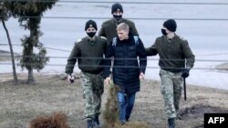 A man is detained in Minsk on March 25, one of at least 170 detained in the capital.