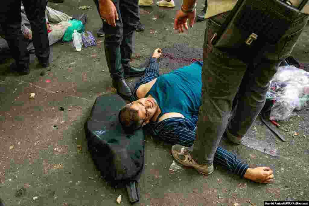 A wounded man awaits medical assistance after an Israeli strike on Tehran on June 15.
