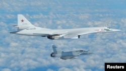 A Russian Blackjack bomber is intercepted and escorted by a French Mirage jet above French coast in this image taken and distributed by the French Air Force in February 2017.