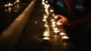 Kosovo citizens lighting candles in front of the theatre in Prishtina, to honor victims of an accident with a bus in Croatia