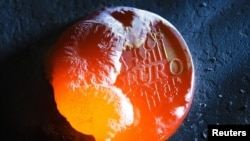 Novčić evra koji se topi - ilustrativna fotografija