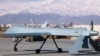 File photo of a drone armed with a missile setting off from its hangar at Bagram air base in Afghanistan.