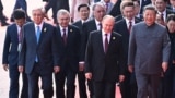 Chinese leader Xi Jinping walks with foreign leaders at a military parade in Beijijng on September 3. 