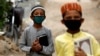 Boys wearing protective masks head to the madrasah in Karachi in July.