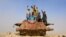 Afghan children play on the remains of a Soviet-era tank on the outskirts of Jalalabad in February.