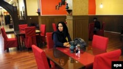 A woman waits for her food at a restaurant in Kabul in 2016. Now she would probably be harassed by Taliban militants, even if not alone.