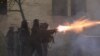 Police in riot gear fire tear gas during a fourth day of nationwide protests against a government decision to shelve EU membership talks in Tbilisi early on December 2, 2024.
