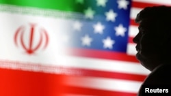 Illustration of a 3D-printed miniature model of U.S. President Donald Trump and the U.S. and Iran flags