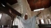 FILE: A Christian woman cries in the church where her son died in a suicide attack in the northwestern city of Peshawar in September 2013.