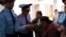 Полицейские задерживают активистку группы алматинских пенсионеров Райхангуль Амирбекову в здании акимата города. Алматы, 4 октября 2013 года.