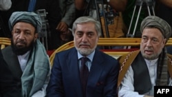 FILE Afghan Chief Executive Abdullah Abdullah (C) sits with his two deputies Mohammad Khan (left) and Mohammad Mohaqiq during a gathering in Kabul in October 2013.